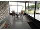 A screened patio offering outdoor seating with four chairs and a table for entertaining or relaxing at 1014 Dustin Dr, Lady Lake, FL 32159