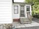 Rear side entrance with a small landing and steps at 1014 Dustin Dr, Lady Lake, FL 32159