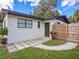 Back exterior showing an outdoor patio with tiled flooring, and white painted brick at 1016 Cottonwood St, Leesburg, FL 34748