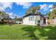 Lush backyard featuring manicured lawn, patio area, and fenced perimeter at 1016 Cottonwood St, Leesburg, FL 34748