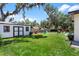 Expansive backyard featuring a shed, playset, and lush green lawn, perfect for outdoor activities at 1016 Cottonwood St, Leesburg, FL 34748