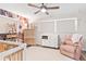 Cozy Bedroom with floral wallpaper accent wall, natural wood furniture, and ceiling fan at 1016 Cottonwood St, Leesburg, FL 34748