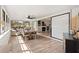 Open dining space featuring lots of windows, a dining table, and an adjacent living area at 1016 Cottonwood St, Leesburg, FL 34748