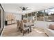 Sunlit dining room with a modern table, chairs, ceiling fan, and sliding glass doors at 1016 Cottonwood St, Leesburg, FL 34748
