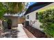 Side of the home with a small stone walkway to a utility shed, showcasing landscaping at 1016 Cottonwood St, Leesburg, FL 34748