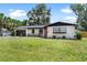 Well-maintained front lawn and landscaping add to the curb appeal of this home at 1016 Cottonwood St, Leesburg, FL 34748