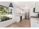 Spacious kitchen featuring stainless steel appliances, white cabinets, and wood-look flooring at 1016 Cottonwood St, Leesburg, FL 34748