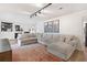 Spacious living room featuring a comfortable sectional sofa, rug, and modern lighting at 1016 Cottonwood St, Leesburg, FL 34748