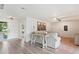 Open-concept living room with stylish decor, modern lighting, and wood-look flooring at 1016 Cottonwood St, Leesburg, FL 34748