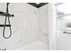 Elegant shower with marble-patterned tile, black hardware, and a built-in caddy at 1016 Cottonwood St, Leesburg, FL 34748