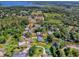 A picturesque aerial shot showcases the property, highlighting its lush surroundings and serene waterfront access at 111 Cardinal Ln, Eustis, FL 32726