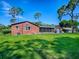 Large backyard featuring lush green grass and mature trees at 111 Cardinal Ln, Eustis, FL 32726