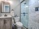 Bathroom featuring a wood-look vanity, toilet, and shower with decorative tile at 111 Cardinal Ln, Eustis, FL 32726