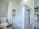 Clean bathroom featuring a tub with shower, white tile, and built-in shelves for toiletries at 111 Cardinal Ln, Eustis, FL 32726