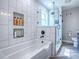 The bathtub features white subway tiles, a glass-enclosed shower, and sleek shower accessories for a spa-like experience at 111 Cardinal Ln, Eustis, FL 32726