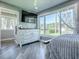 Relax in this bedroom with a view, showcasing a bright window, white dresser, and airy curtains at 111 Cardinal Ln, Eustis, FL 32726