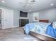 Bedroom offers wood-look flooring, a queen sized bed, ceiling fan, dresser, and windows with natural light at 111 Cardinal Ln, Eustis, FL 32726