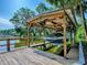 View of the dock with boat inside the shelter at 111 Cardinal Ln, Eustis, FL 32726