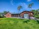 Back exterior of the home with a large backyard, screened in porch and two car garage at 111 Cardinal Ln, Eustis, FL 32726