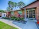 Close-up of a well-maintained brick house with manicured landscaping and a charming front entrance at 111 Cardinal Ln, Eustis, FL 32726