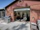 View of a partially open garage with a home gym and stainless steel grill at 111 Cardinal Ln, Eustis, FL 32726
