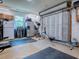 Inside the home's garage reveals a personal gym with stainless steel refrigerator at 111 Cardinal Ln, Eustis, FL 32726