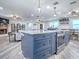 Kitchen with island and seating shows an open floorplan into the living room with fireplace and dining room area at 111 Cardinal Ln, Eustis, FL 32726