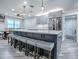 Kitchen featuring seating at an island, stainless steel appliances, tile backsplash, granite countertops and gray shaker style cabinets at 111 Cardinal Ln, Eustis, FL 32726