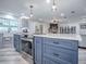 Open kitchen shows granite counters, an island with a stainless steel oven, and a view into a living room with fireplace at 111 Cardinal Ln, Eustis, FL 32726