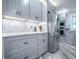 Kitchen featuring stainless steel appliances, sleek gray cabinets, tile backsplash and granite countertops at 111 Cardinal Ln, Eustis, FL 32726