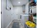 A well-organized laundry room with modern appliances, storage shelves, and ample floor space at 111 Cardinal Ln, Eustis, FL 32726