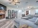 Open living space with a brick fireplace, gray sectional, and stylish decor at 111 Cardinal Ln, Eustis, FL 32726