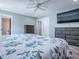 This main bedroom features a floral bedspread, gray dressers, and an ensuite bathroom for a luxurious retreat at 111 Cardinal Ln, Eustis, FL 32726