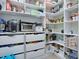 Walk in pantry with floor to ceiling storage shelves with canned and dry goods, plus a small microwave and drawers at 111 Cardinal Ln, Eustis, FL 32726