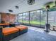 An inviting screened porch features comfortable seating and views of the landscaped yard at 111 Cardinal Ln, Eustis, FL 32726