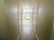Hallway view into ensuite bathroom with shower and soaker tub at 11301 Via Mari Cae Ct, Clermont, FL 34711