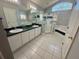 Bathroom with dual sinks, a shower, and a soaking tub under a window at 11301 Via Mari Cae Ct, Clermont, FL 34711