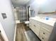 Bathroom featuring gray walls, wood look flooring, white vanity, and shower/tub at 11301 Via Mari Cae Ct, Clermont, FL 34711