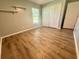 Bedroom with laminate flooring, closet, floating shelves, and a window at 11301 Via Mari Cae Ct, Clermont, FL 34711