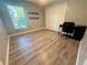 Bedroom featuring laminate flooring, closet, floating shelves, desk, and a window at 11301 Via Mari Cae Ct, Clermont, FL 34711