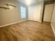 Vacant bedroom with hard surface floors, shelves, and white closet doors at 11301 Via Mari Cae Ct, Clermont, FL 34711