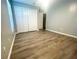 An empty bedroom with natural lighting and neutral-toned walls and light wood flooring at 11301 Via Mari Cae Ct, Clermont, FL 34711