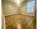Empty bedroom with wood-look floors, two shelves and a bright window at 11301 Via Mari Cae Ct, Clermont, FL 34711
