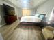 Neutral bedroom features a comfy armchair, side table, and hard surface flooring at 11301 Via Mari Cae Ct, Clermont, FL 34711