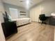 Bedroom with light wood flooring, desk, large window, and double door closet at 11301 Via Mari Cae Ct, Clermont, FL 34711