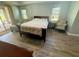 Calm bedroom with a comfy bed, patio access, and lots of natural light at 11301 Via Mari Cae Ct, Clermont, FL 34711