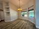 Inviting dining room featuring a modern chandelier, built-in shelves, and views of the pool at 11301 Via Mari Cae Ct, Clermont, FL 34711