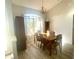 Bright dining room features a wooden table, chairs, and large windows allowing for lots of natural light at 11301 Via Mari Cae Ct, Clermont, FL 34711