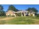 Beautiful single Gathering home with well-manicured lawn and lush landscaping, enhancing curb appeal at 11301 Via Mari Cae Ct, Clermont, FL 34711