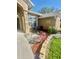 Charming front porch featuring a stone accent column and a seating area perfect for enjoying the outdoors at 11301 Via Mari Cae Ct, Clermont, FL 34711